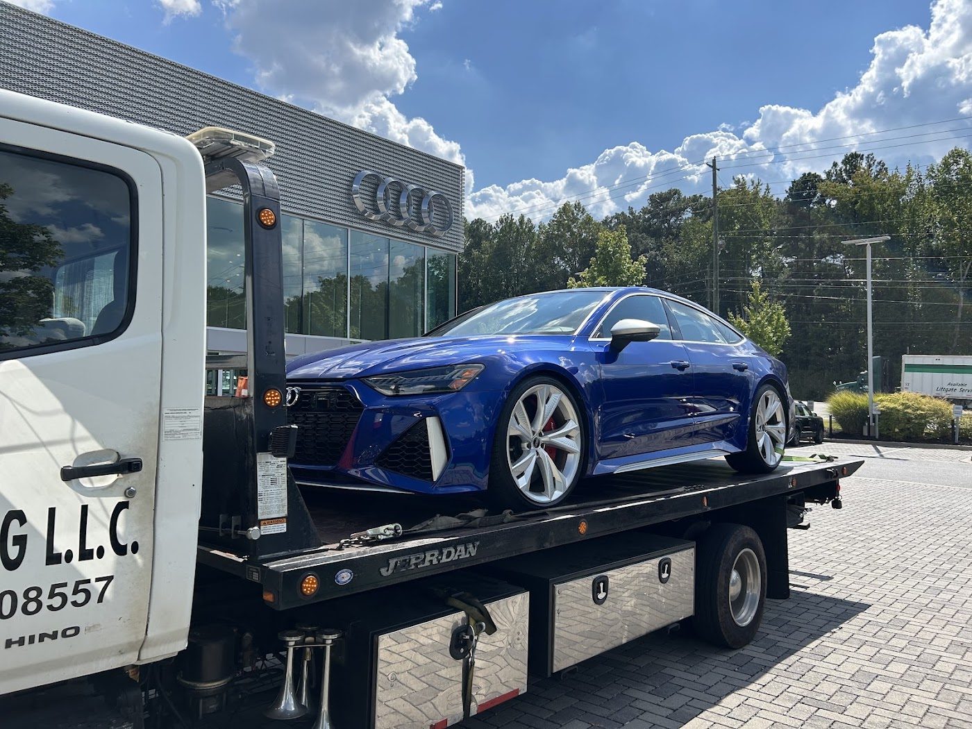 Blue sedan on a flatbed